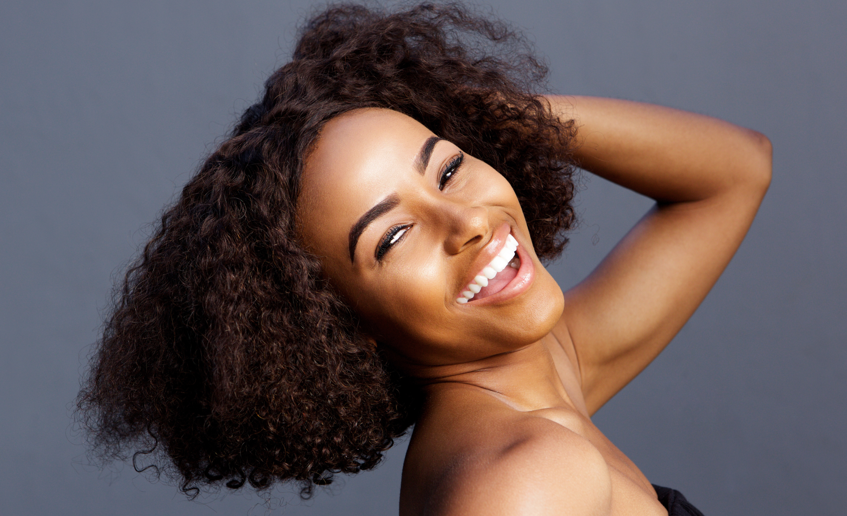 Happy woman with high volume hair extensions