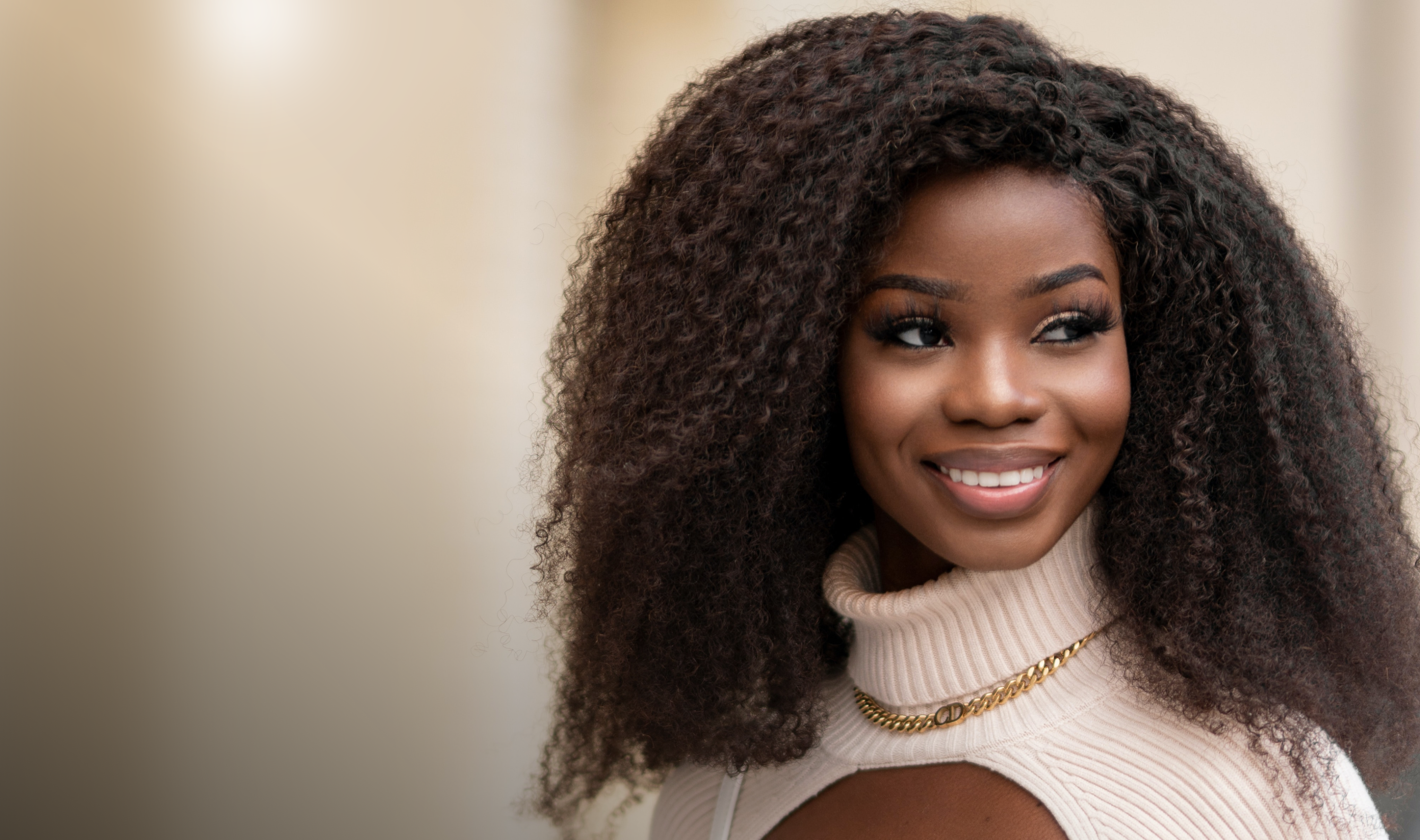 Smiling woman with black curly hair