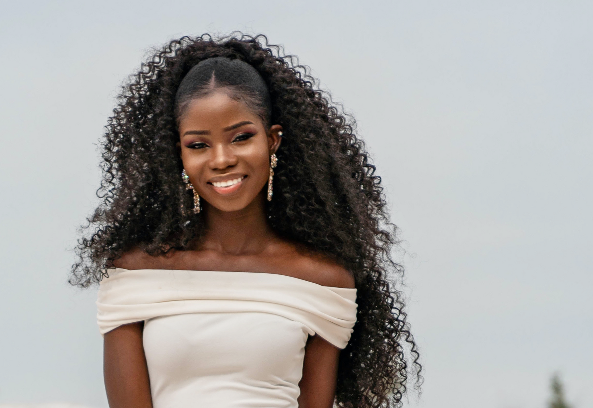 Elegant woman wearing high volume hair extensions