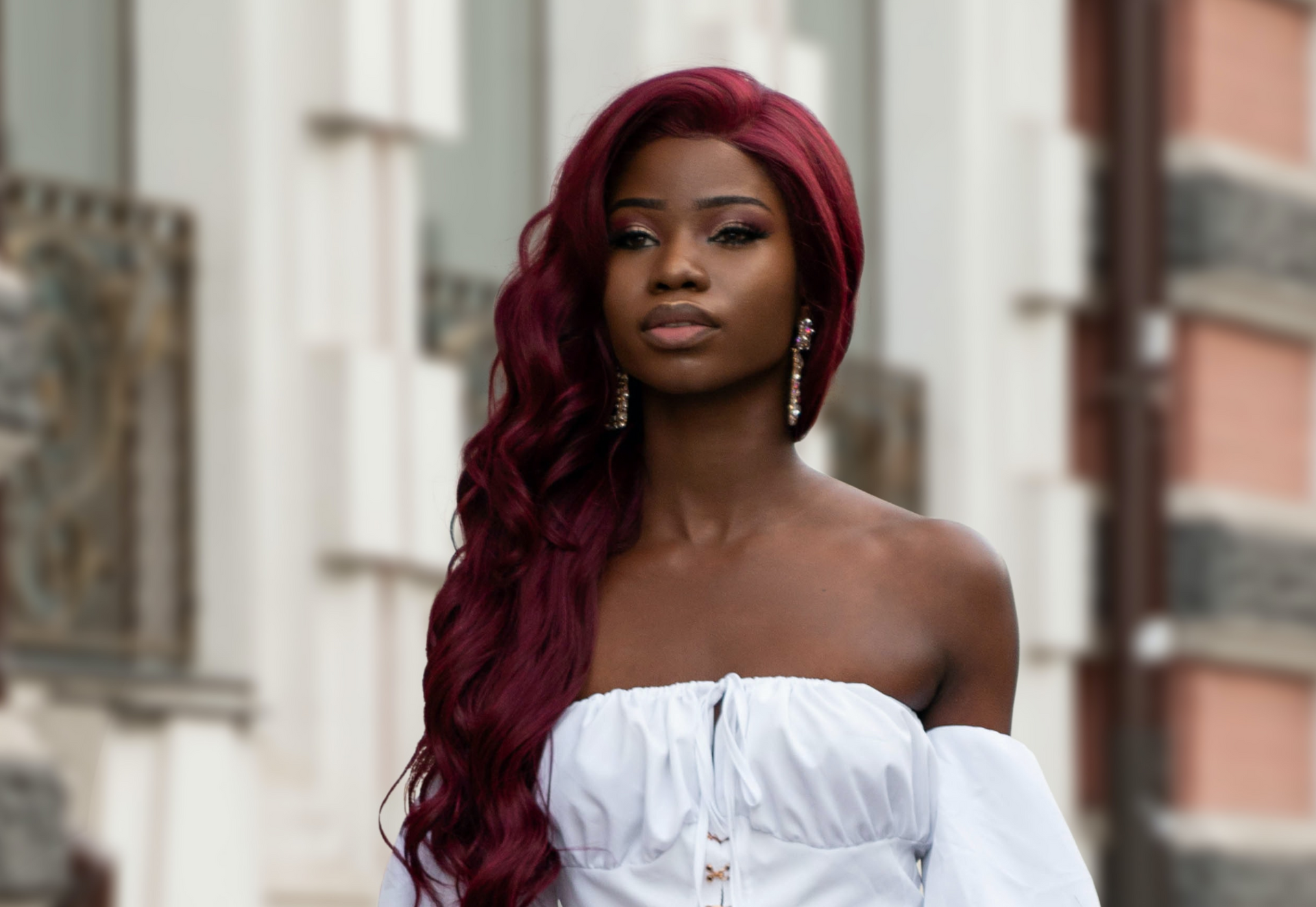 Woman wearing red wavy hair extensions