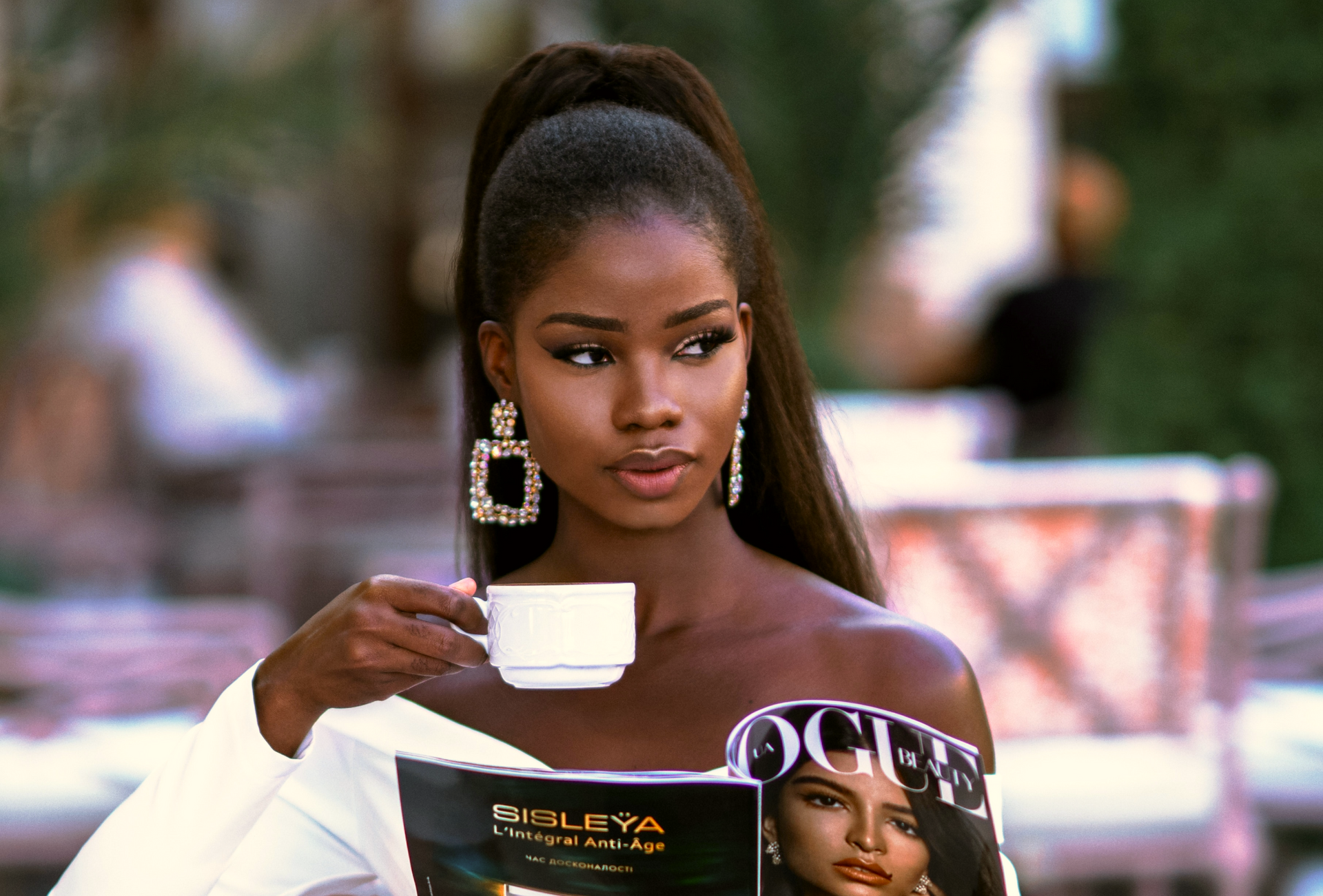 Elegant woman drinking tea and wearing long straight hair extensions